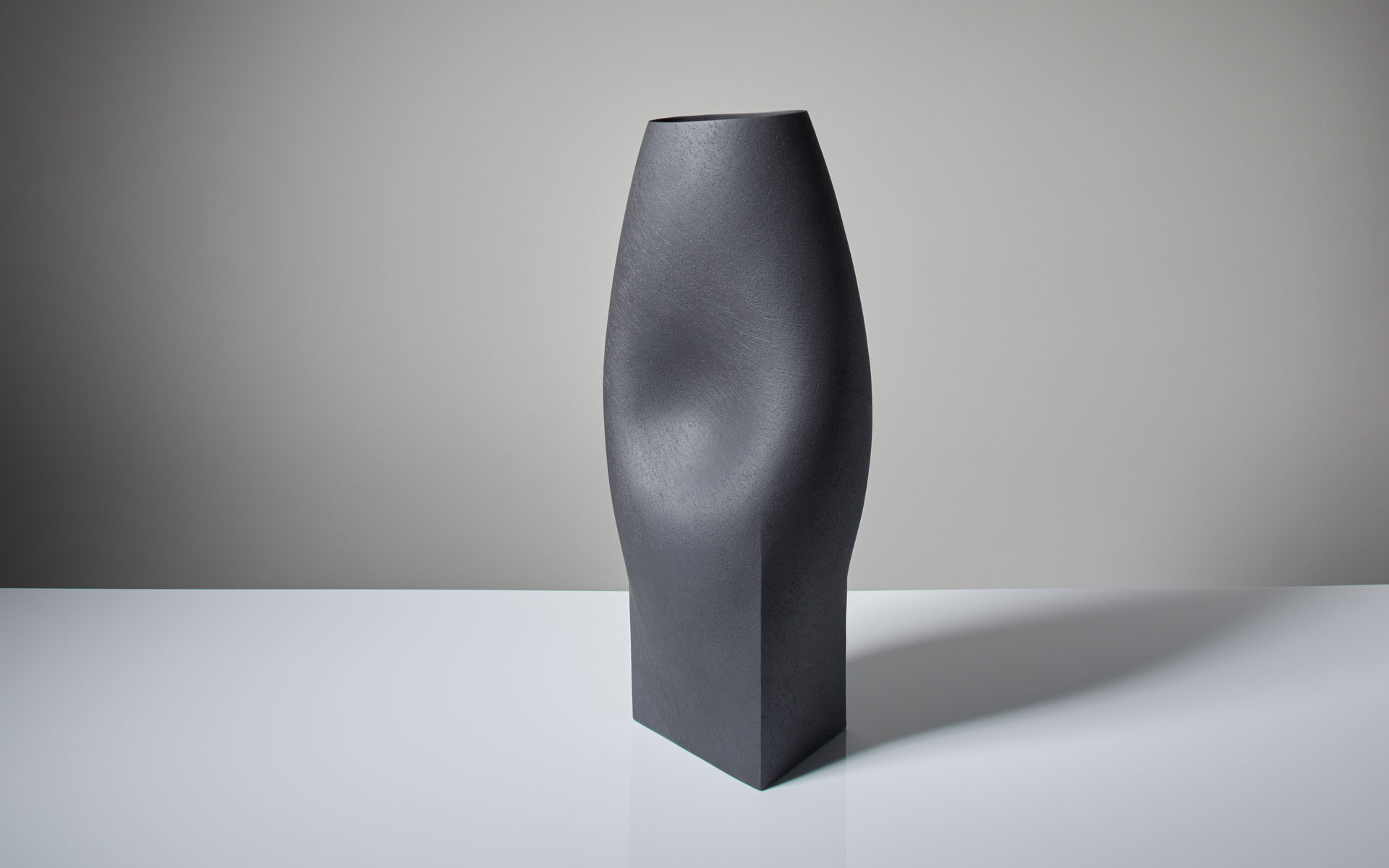 Black vessel with triangular base